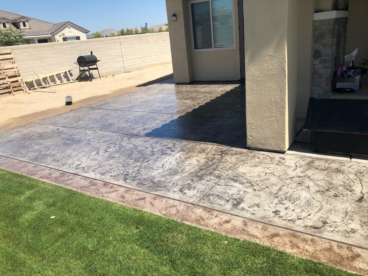 Textured stamped-concrete patio behind a Bakersfield home