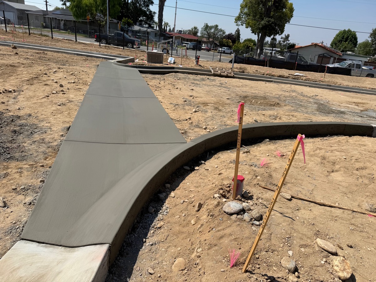Freshly poured curved concrete sidewalk and flatwork