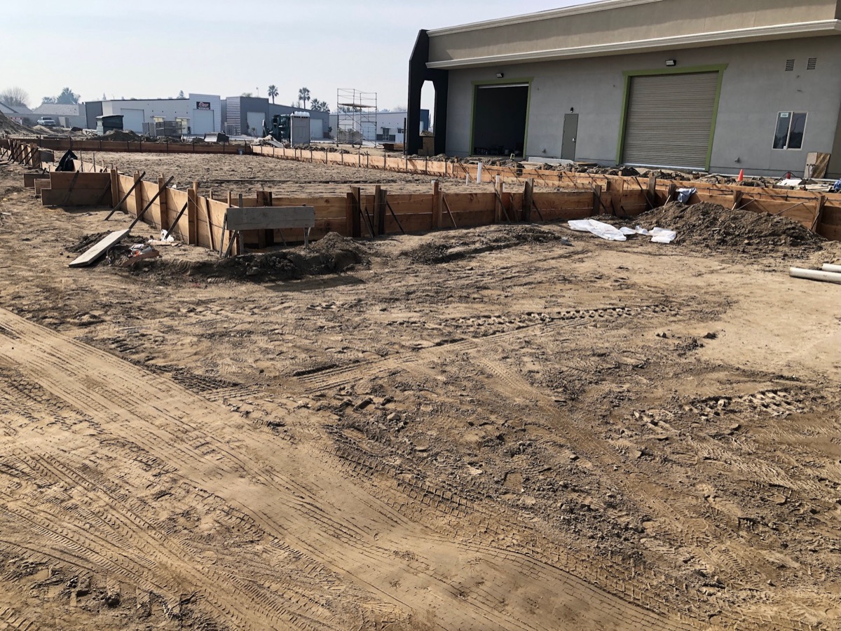 Formed footings and graded pad ready for a commercial concrete pour