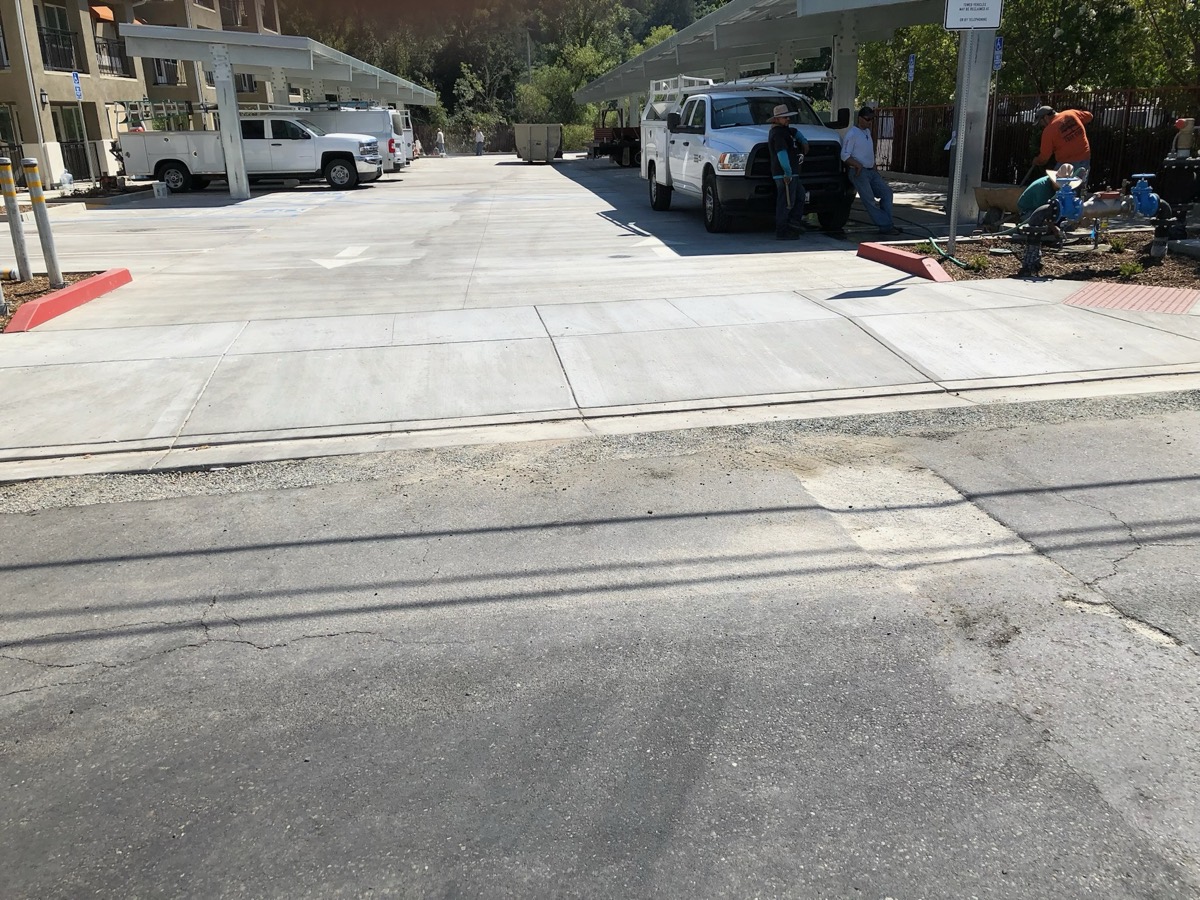 Finished concrete driveway and approach with poured curbs